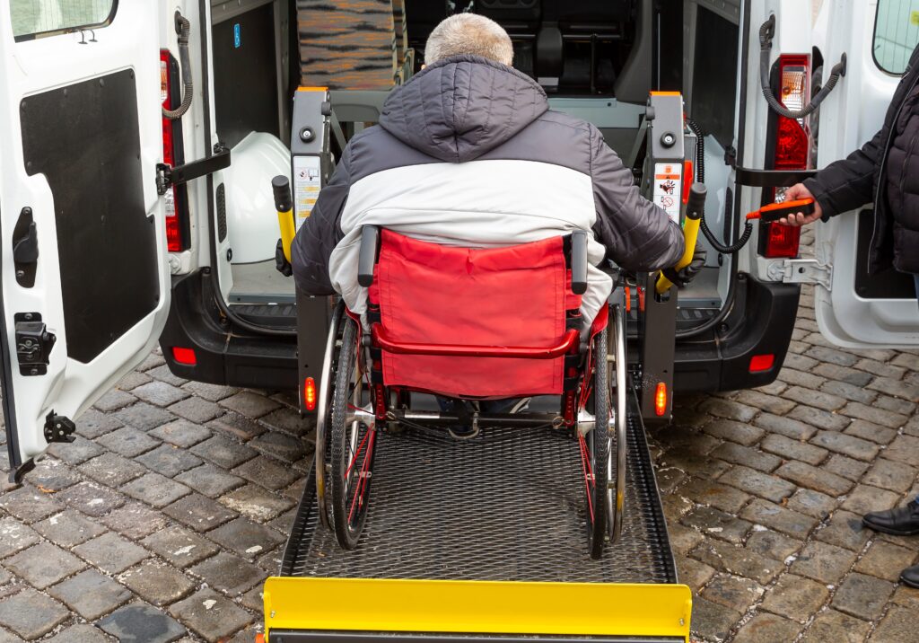 Minibus for handicapped, physically challenged and disabled people in wheelchairs. Minibus with stowed wheelchair ramp.