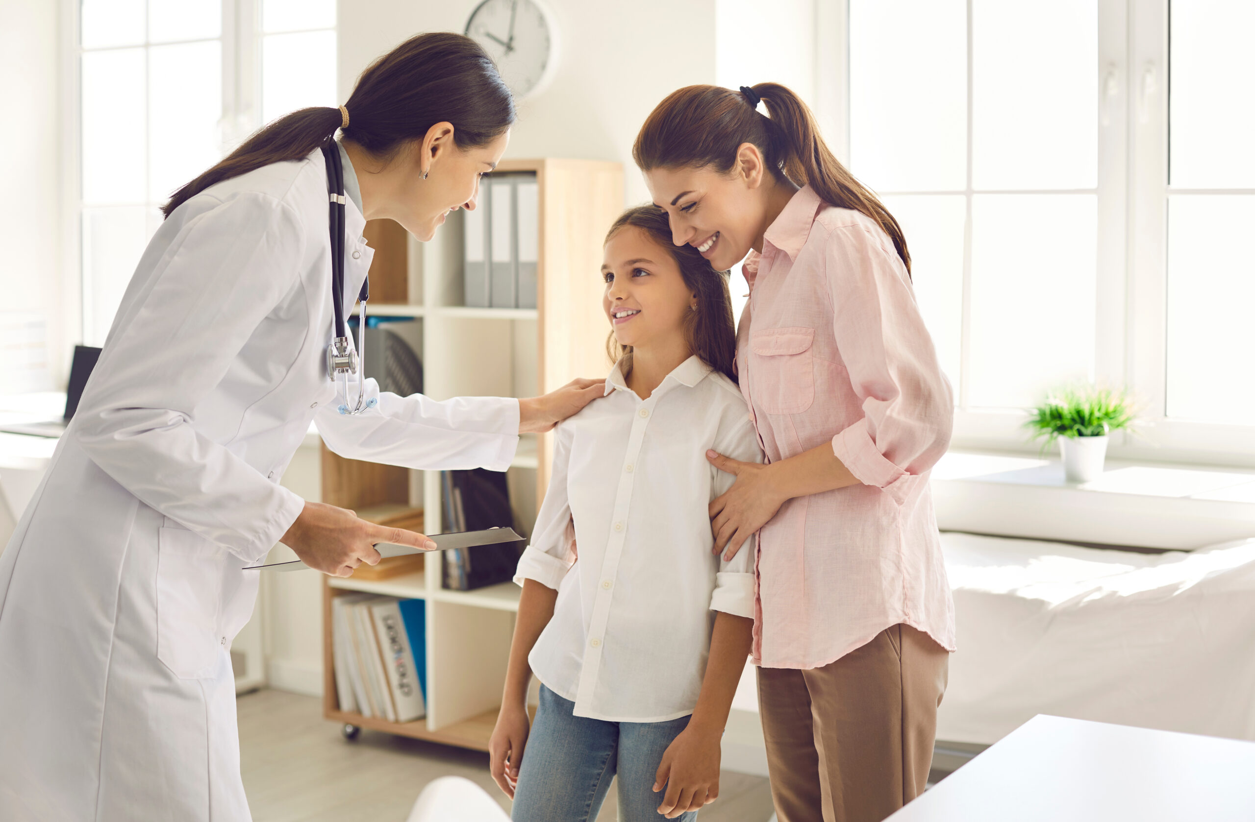 doctor talks to the mother with teenage daughter